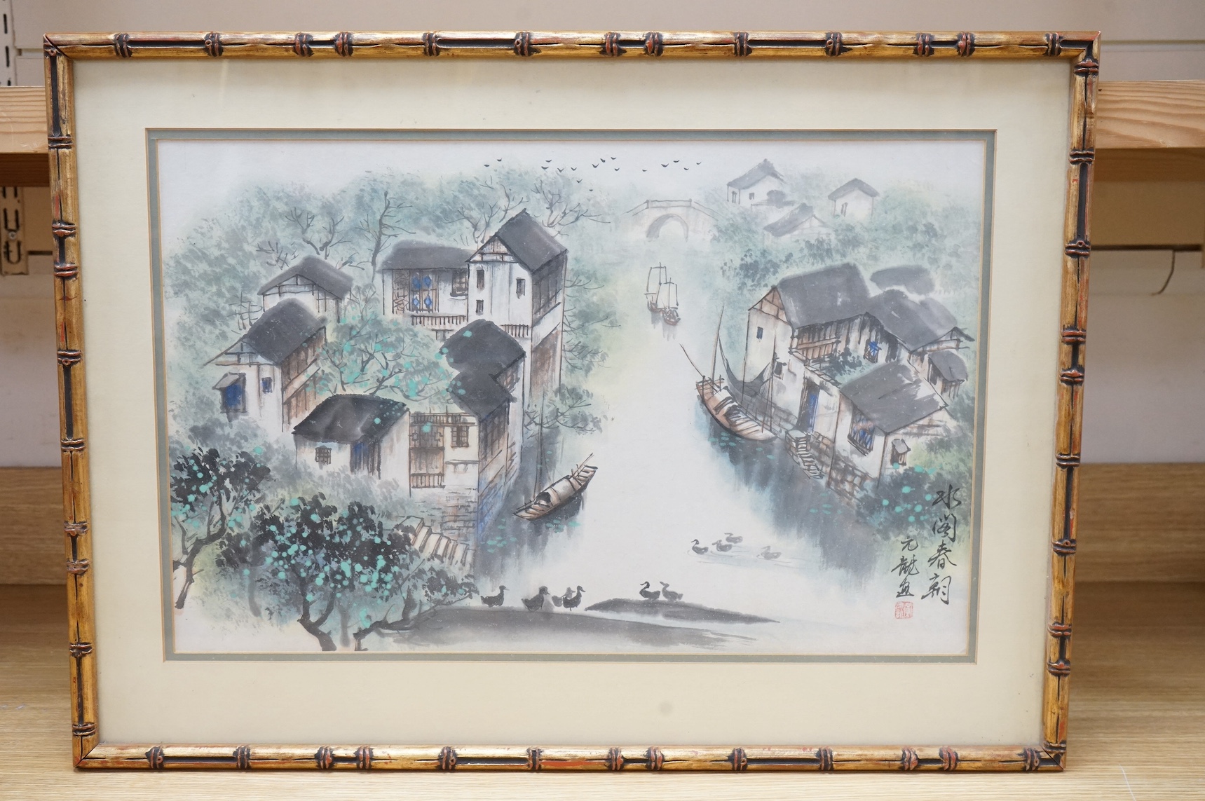 20th century, Chinese School, ink and watercolour, Riverscape with junks, signed with character and red seal marks, 35 x 53cm, housed in a bamboo style frame. Condition - fair